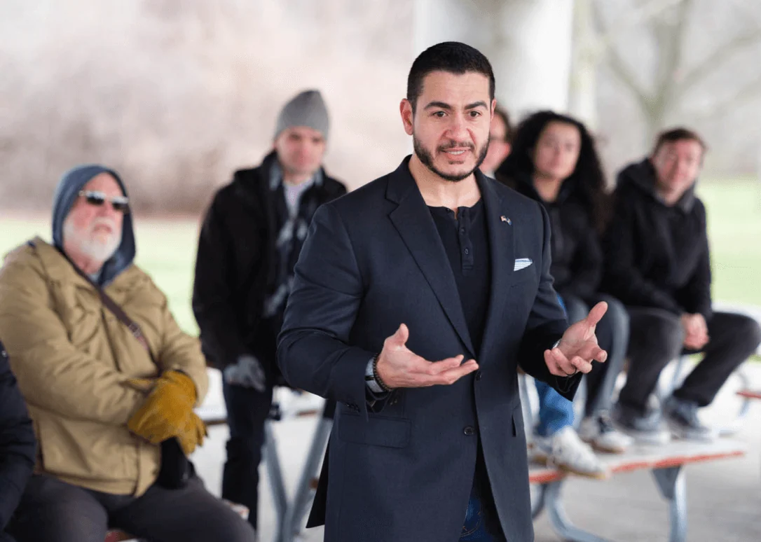 Abdul El-Sayed speaking with voters outdoors